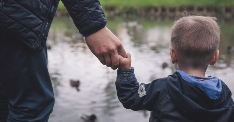 Boy holds a hand (public domain photo)