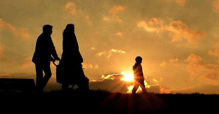 Family walks at sunset (public domain image)
